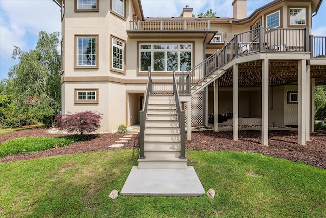 197 River Bend Dr, Clarks Hill, SC 29821 - back of property featuring stairway, stucco siding, a chimney, and a yard