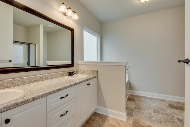 bathroom featuring a washtub and vanity