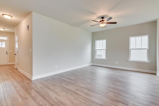 empty room featuring ceiling fan and light hardwood / wood-style flooring