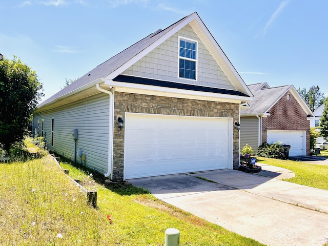 2054 Dundee Way, Grovetown, GA 30813 - view of side of home featuring stone siding, a garage, and a yard