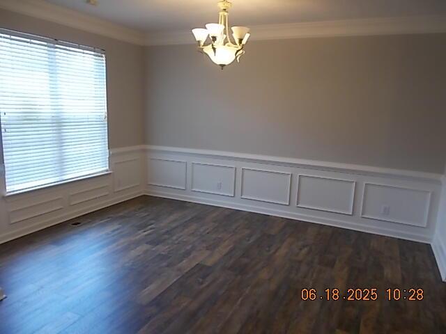967 Windmill Pkwy, Evans, GA 30809 - unfurnished room featuring a chandelier, crown molding, dark wood-style floors, a wainscoted wall, and a decorative wall