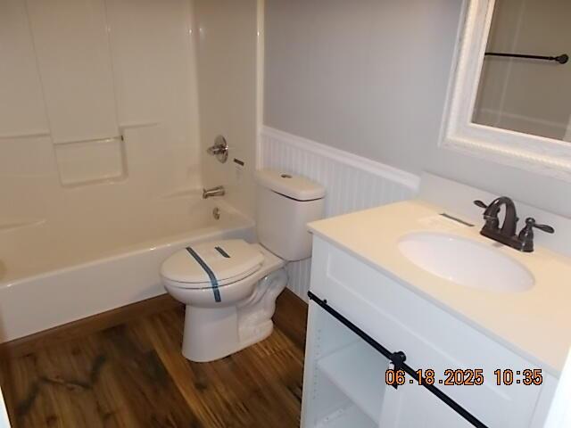 967 Windmill Pkwy, Evans, GA 30809 - bathroom with a wainscoted wall, vanity, wood finished floors, and  shower combination