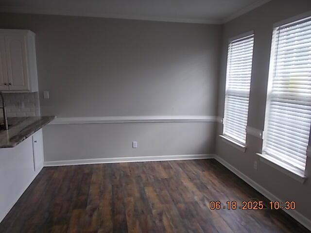 967 Windmill Pkwy, Evans, GA 30809 - unfurnished dining area featuring dark wood-style floors and crown molding