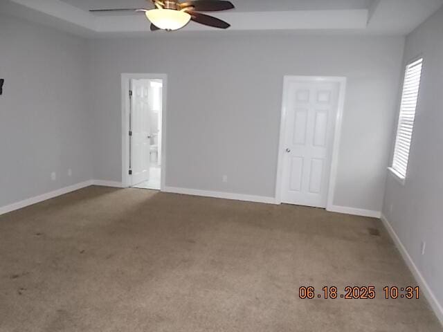 967 Windmill Pkwy, Evans, GA 30809 - carpeted empty room featuring a raised ceiling, ceiling fan, and plenty of natural light
