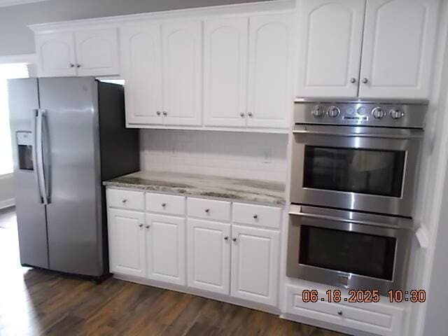 967 Windmill Pkwy, Evans, GA 30809 - kitchen with appliances with stainless steel finishes, light stone counters, dark wood-style flooring, and white cabinets