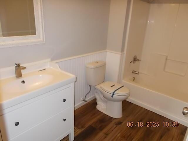 967 Windmill Pkwy, Evans, GA 30809 - bathroom featuring a wainscoted wall, vanity, wood finished floors, and  shower combination