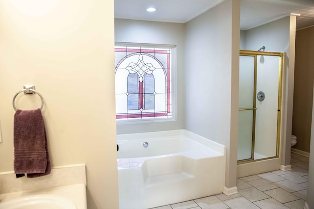 full bathroom featuring toilet, tile patterned floors, separate shower and tub, and sink