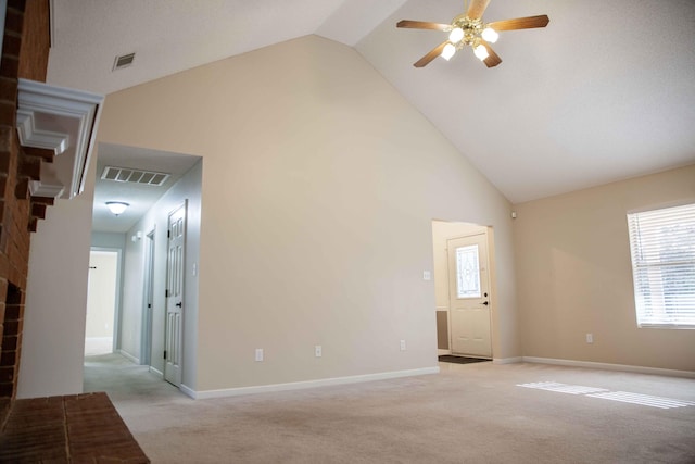 unfurnished room with ceiling fan, a fireplace, light carpet, and high vaulted ceiling