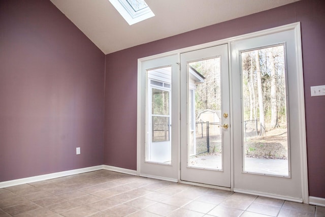 entryway featuring light tile patterned floors and lofted ceiling with skylight