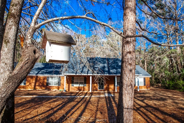 view of front of home with a storage shed