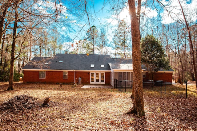 rear view of house featuring a sunroom