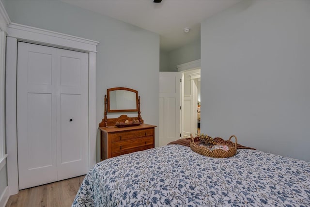 bedroom featuring light wood-type flooring and a closet