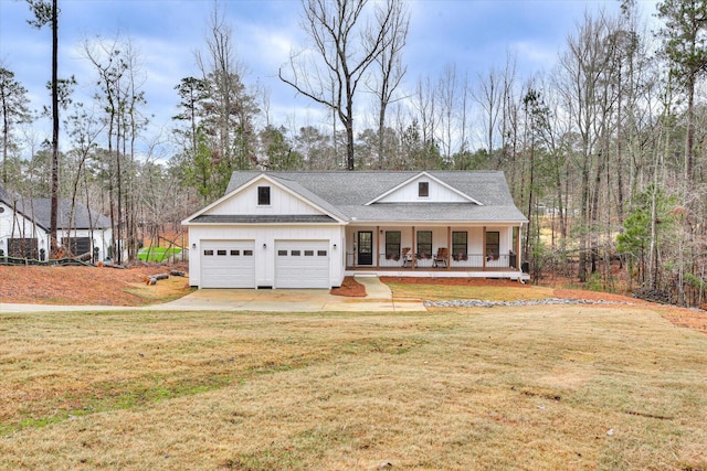 view of front of house with a front lawn, a porch, and a garage