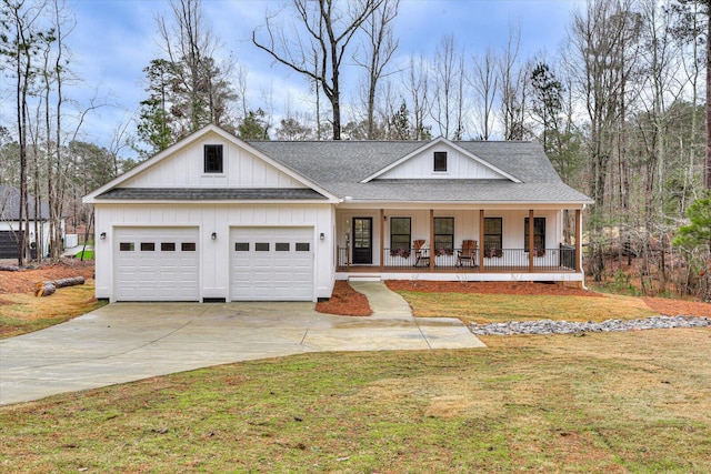 view of front facade with a front lawn, covered porch, and a garage