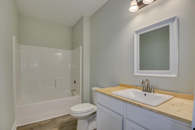 full bathroom with wood-type flooring, vanity, toilet, and tub / shower combination