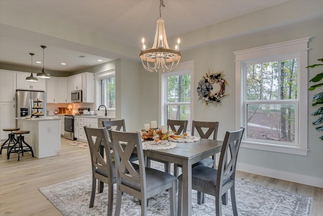 dining room featuring light hardwood / wood-style flooring and a chandelier