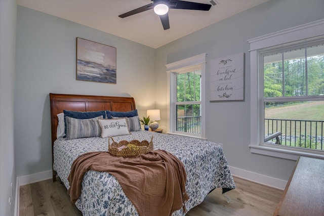 bedroom with light hardwood / wood-style flooring and ceiling fan