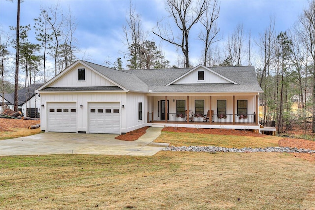 view of front of property with a front lawn, covered porch, and a garage