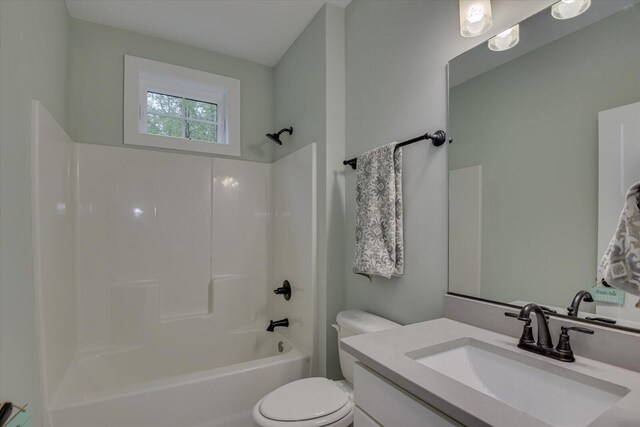 full bathroom featuring vanity, shower / bathing tub combination, and toilet