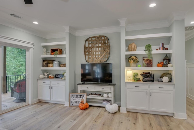 living room featuring light hardwood / wood-style floors, ornamental molding, and built in features