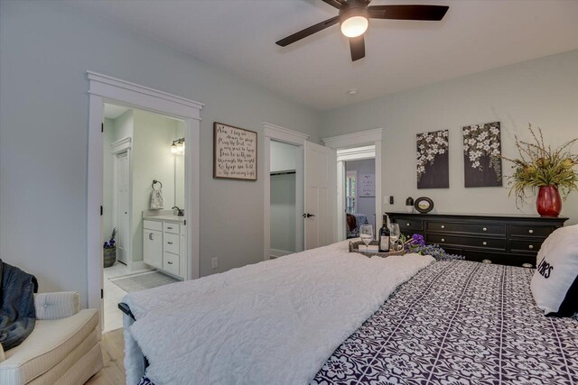 bedroom featuring ensuite bathroom and ceiling fan