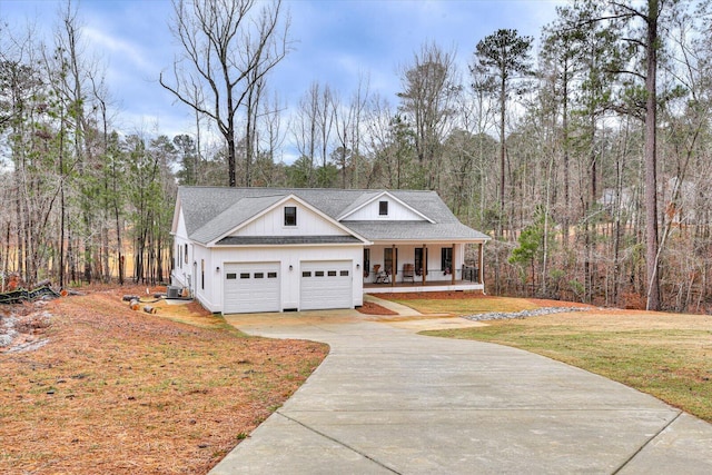 view of front facade with cooling unit, a garage, a porch, and a front yard