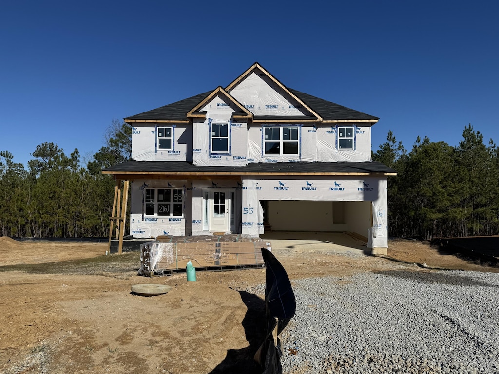 view of front facade featuring covered porch and a garage