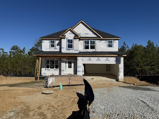 view of front facade featuring covered porch and a garage