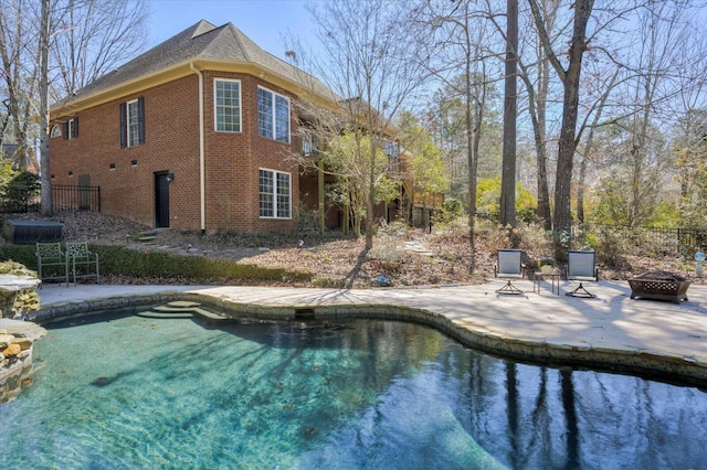 view of pool featuring an outdoor fire pit, fence, and a patio