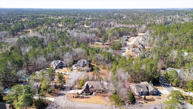 birds eye view of property with a view of trees