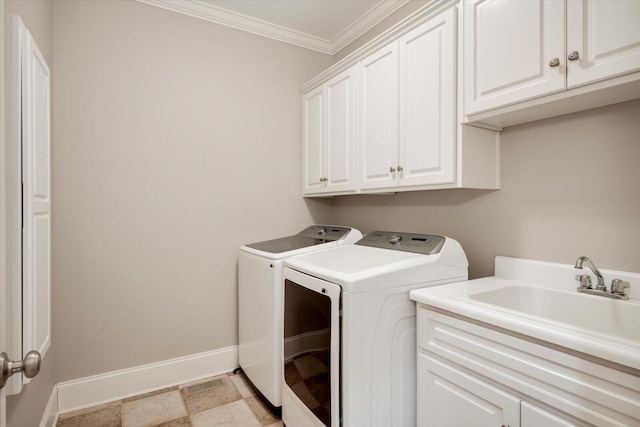 laundry area featuring washer and clothes dryer, cabinet space, ornamental molding, a sink, and baseboards