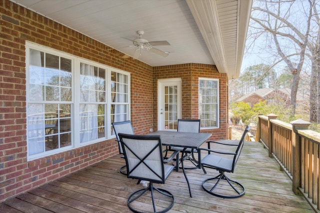 wooden deck with a ceiling fan and outdoor dining area