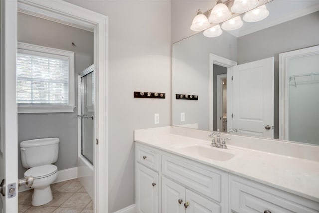 full bath featuring toilet, shower / bath combination with glass door, vanity, baseboards, and tile patterned floors