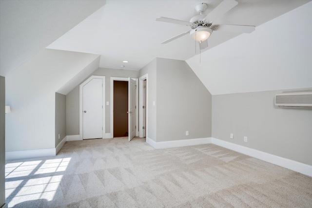 bonus room featuring lofted ceiling, carpet, baseboards, and a wall mounted AC