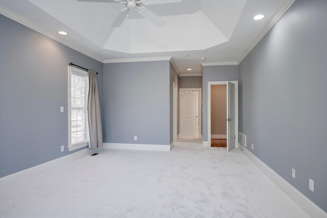 unfurnished bedroom featuring light carpet, baseboards, visible vents, a tray ceiling, and recessed lighting