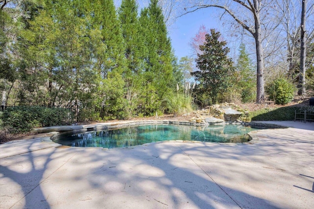 outdoor pool with a patio area