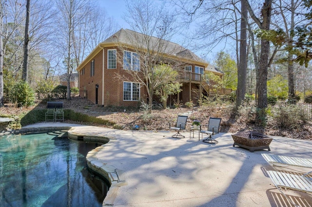 back of property featuring an outdoor fire pit, brick siding, a patio, and stairs