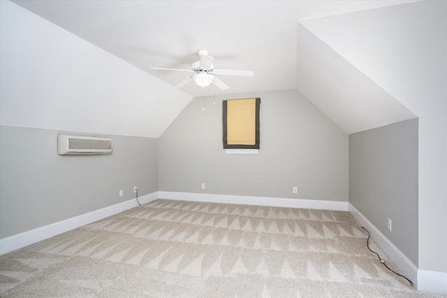 bonus room featuring carpet floors, a wall unit AC, vaulted ceiling, and baseboards