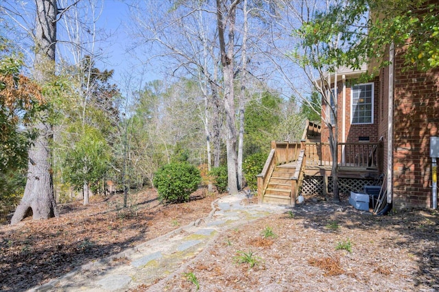 view of yard with a wooden deck and stairs