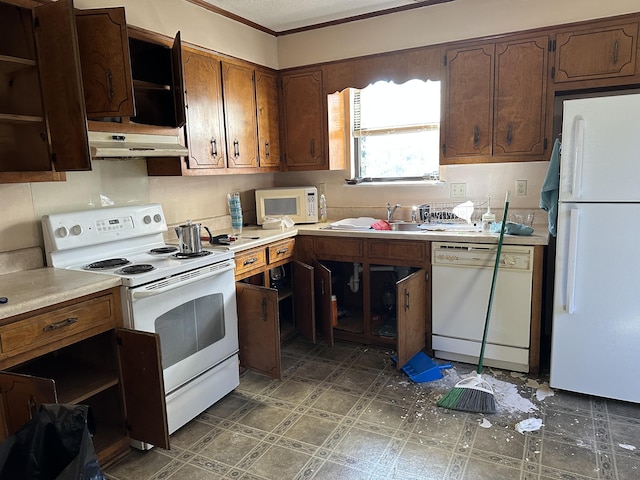 kitchen with crown molding, sink, and white appliances