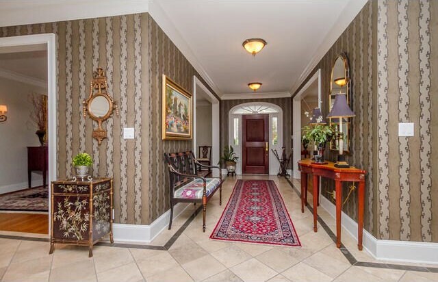 tiled entrance foyer with ornamental molding