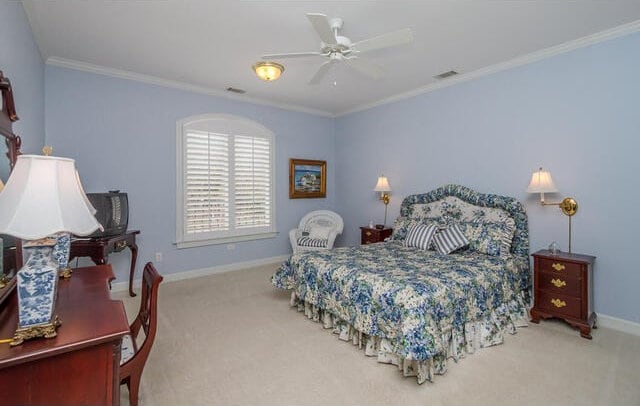 bedroom with ceiling fan, light colored carpet, and ornamental molding