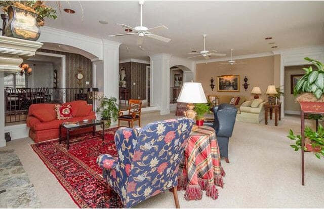 living room featuring crown molding and light carpet