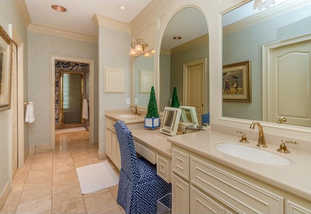 bathroom with tile patterned floors, crown molding, and vanity