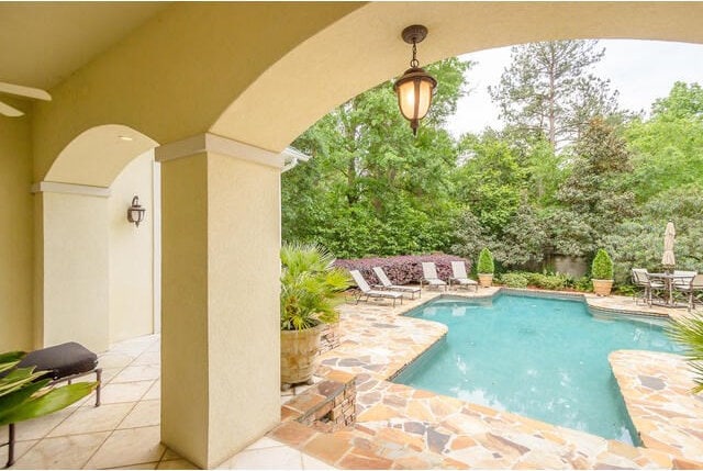 view of pool with a patio and ceiling fan