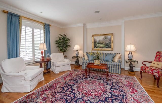 living room featuring light wood-type flooring and ornamental molding