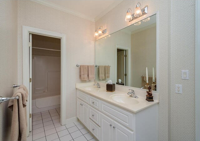 bathroom with tile patterned flooring, vanity, and crown molding