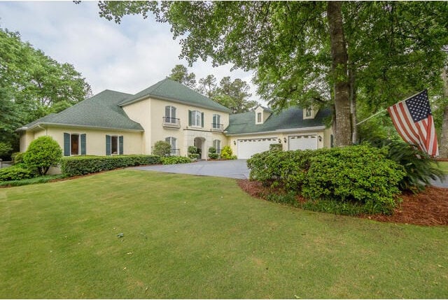 view of front of property with a front yard and a garage