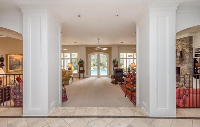 hallway with light tile patterned flooring and french doors