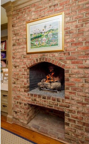 room details with crown molding, a fireplace, and wood-type flooring